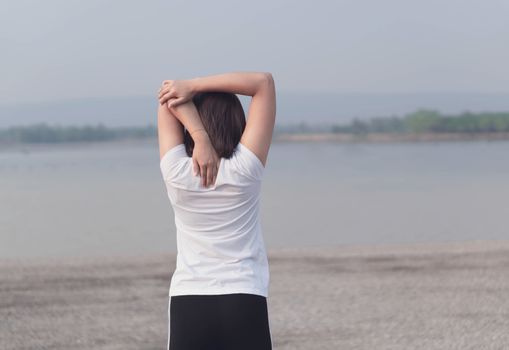 Closeup woman warm up and stretching exercises for running with nature background, vintange tone