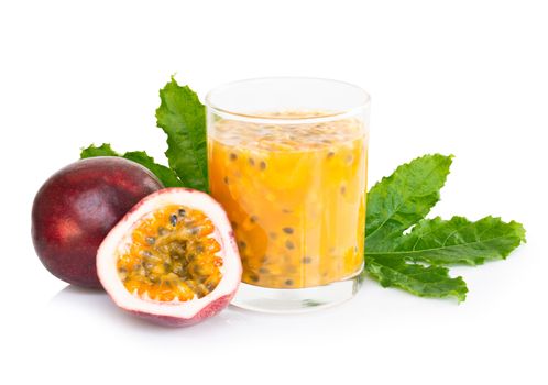 Fresh passion fruit juice in glass with green leaf isolated on white background, fruit healthy concept