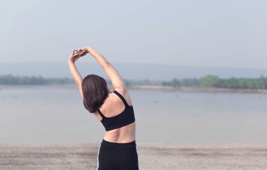 Closeup woman warm up and stretching exercises for running with nature background, vintange tone