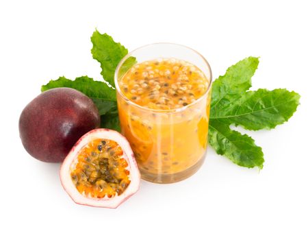 Fresh passion fruit juice in glass with green leaf isolated on white background, fruit healthy concept