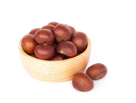 Closeup horse chestnuts in wood bowl isolated on white background,  healthy food concept