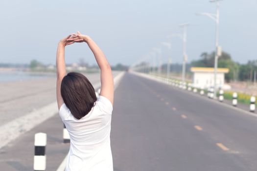 Closeup woman warm up and stretching exercises for running with nature background, vintange tone