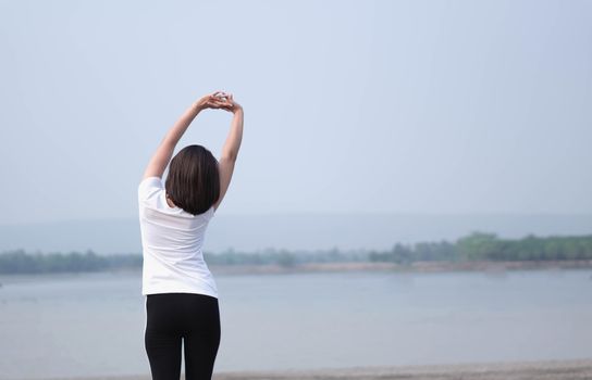 Closeup woman warm up and stretching exercises for running with nature background, vintange tone