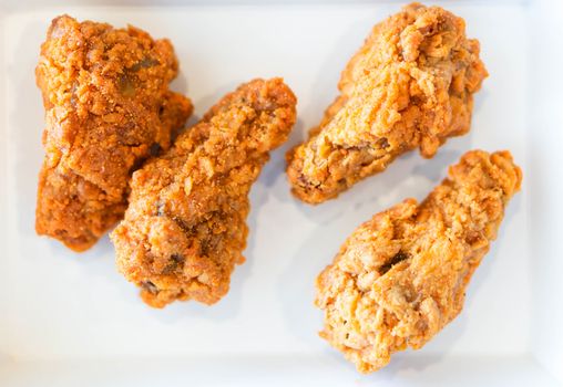 Close up fried chicken legs in white tray