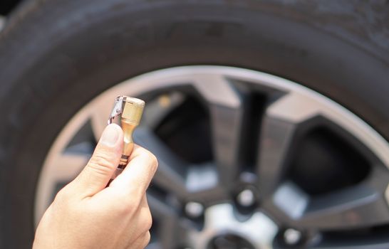 Close up man hand filling wind of the car, selective focus