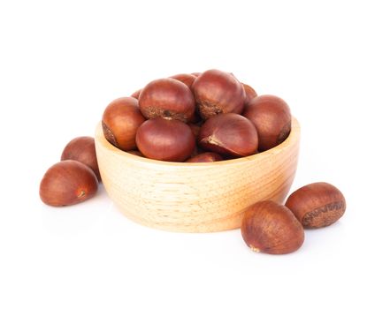 Closeup horse chestnuts in wood bowl isolated on white background,  healthy food concept