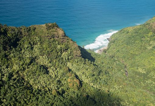 Aerial view of Hanakoa Falls on hawaiian island of Kauai from helicopter flight