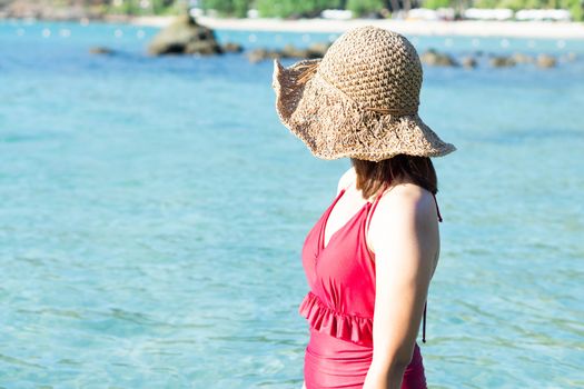 Closeup woman wearing red bikini looking to sea with relax feeling in tropical summer season, Hoilday concept 