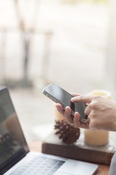 Woman using smart phone in coffee shop, stock photo