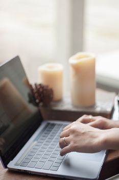 Woman working on computer in coffee shop, stock photo