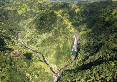 Aerial view of Manawaiopuna Falls and landscape of hawaiian island of Kauai from helicopter flight