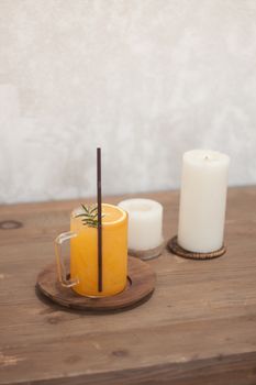 Glass of fresh orange juice with slice on wooden table