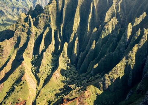 Aerial view of Na Pali mountains and landscape of hawaiian island of Kauai from helicopter flight