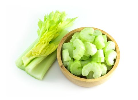 Fresh celery vegetable in wood bowl and sliced  isolated on white background, food for health