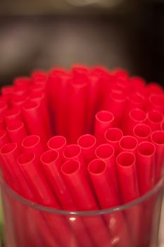 Red straws plastic drinking background, stock photo