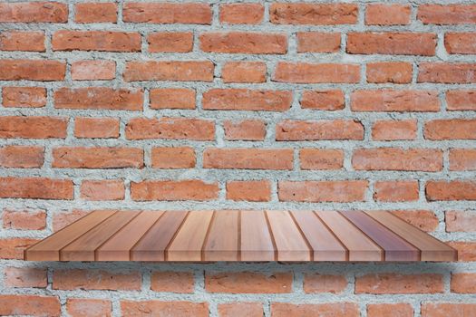 Brown wooden shelf on brick wall. For product display