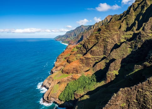 Aerial view of Na Pali coastline and landscape of hawaiian island of Kauai from helicopter flight