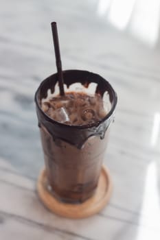 Ice coffee on wooden table, stock photo