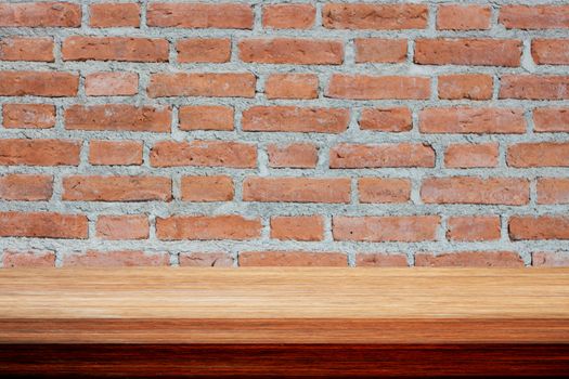 Old wooden table on brick wall, stock photo