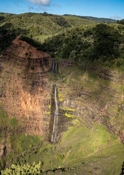 Aerial view of Waipo'o waterfall and landscape of Waimea Canyon of Kauai from helicopter flight