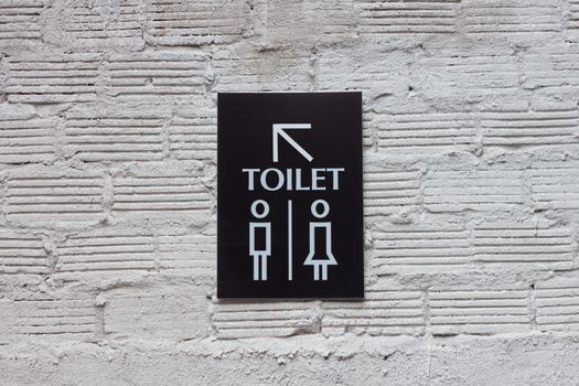 Toilet signs on white wall background, stock photo