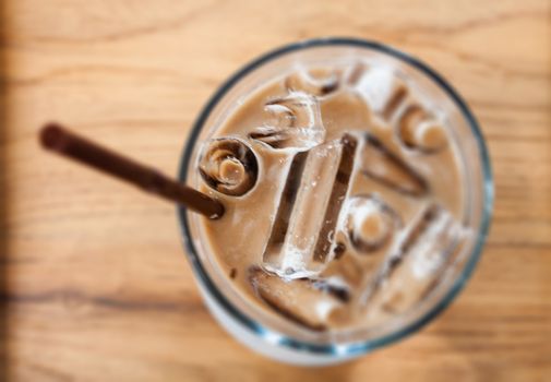 Iced coffee in coffee shop on wooden table, stock photo