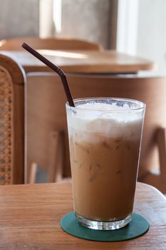 Iced coffee in coffee shop on wooden table, stock photo