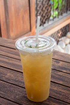 Iced coffee in coffee shop on wooden table, stock photo