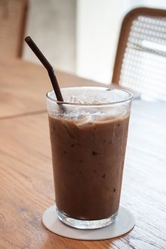 Iced coffee in coffee shop on wooden table, stock photo