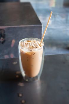 Iced coffee in coffee shop on wooden table, stock photo