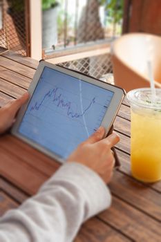 Woman hand trading online on tablet, stock photo