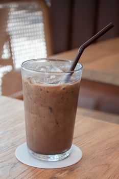 Iced coffee in coffee shop on wooden table, stock photo