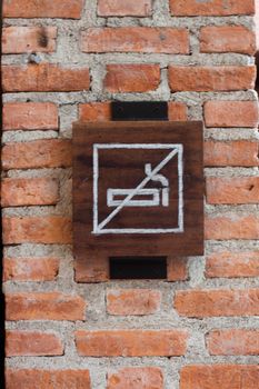 NO smoking sign on brick wall, stock photo