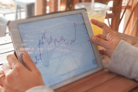 Woman hand trading online on tablet, stock photo