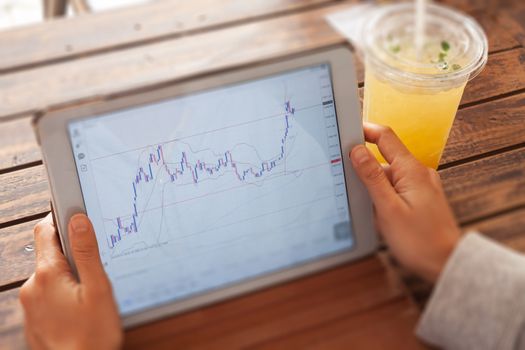 Woman hand trading online on tablet, stock photo