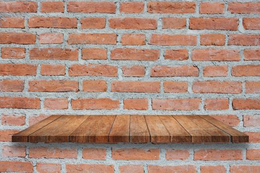 Top of broen wooden shelf on old brick wall. For product display