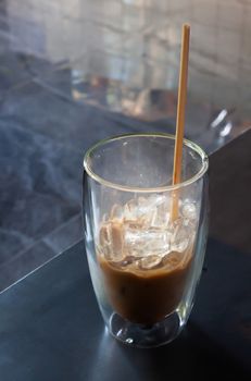 Iced coffee in coffee shop on wooden table, stock photo