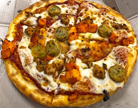 Beautiful view of sliced chicken pizza served in the restaurant for eating