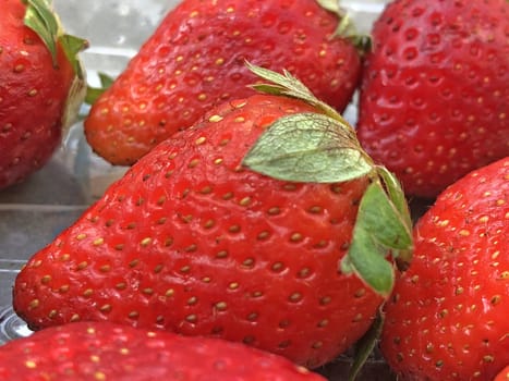 Beautiful view of red color strawberry fruit kept for sale in the market