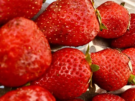 Beautiful view of red color strawberry fruit kept for sale in the market