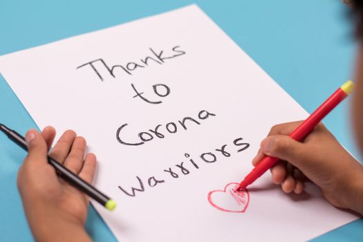 Kid Painting Thanks to corona warriors poster - Concept of showing preparation to gratitude for coronavirus or covid-19 healthcare and essential workers workers