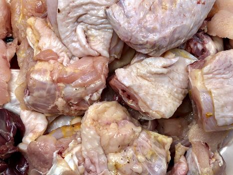 Small pieces of raw chicken meat kept in a plate for cooking