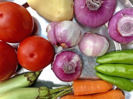 Top view of variety of colorful vegetables kept in a plate for preparing lunch