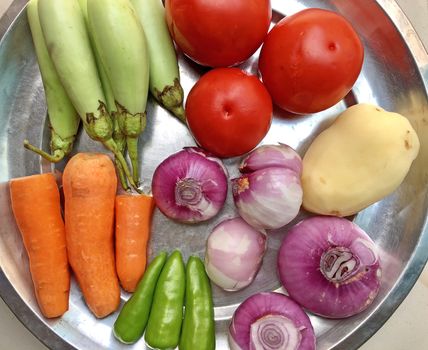 Top view of variety of colorful vegetables kept in a plate for preparing lunch