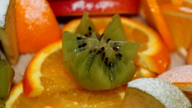 Fruit salad of kiwi, orange, citrus and Apple. Vitamin Breakfast and fresh fruit salad for a healthy lifestyle.