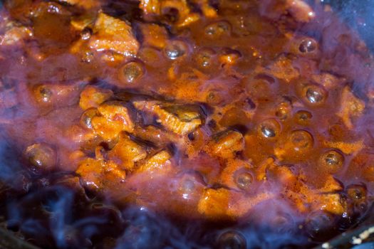 Cooking at home. Cooking meat with gravy. Fried pieces of meat in a pan. Roasted meat.