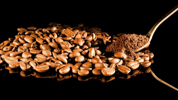 Coffee beans close-up with a spoon of ground coffee on a mirror background.