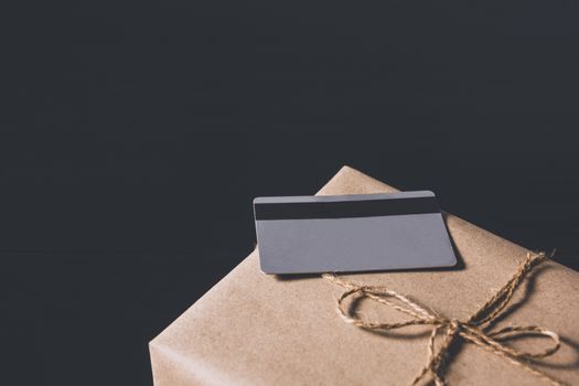 The grey credit card on a box for online shopping and business concept.