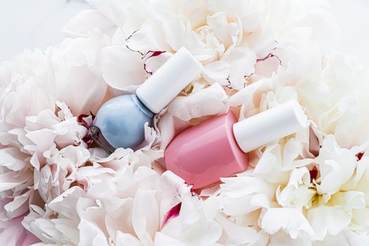 Nail polish bottles on floral background, french manicure and cosmetic branding design