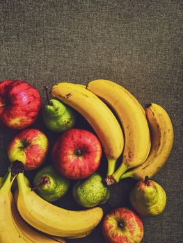 Organic apples, pears and bananas on rustic linen background, fruits farming and agriculture